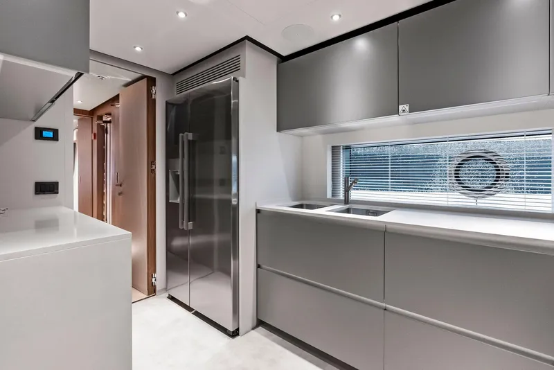 Slide: The Image of Modern kitchen interior on 2023 Custom Line 106' yacht, featuring sleek cabinetry and stainless steel appliances. - 25