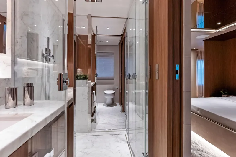 Slide: The Image of Luxurious yacht bathroom with marble accents, modern fixtures, and wooden cabinetry, 2023 Custom Line 106'. - 30