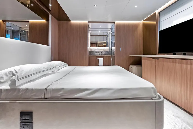 Slide: The Image of Luxurious bedroom interior on 2023 Custom Line 106' yacht, featuring modern design and elegant wood finishes. - 34