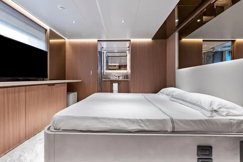 Slide: The Image of Luxurious bedroom interior on 2023 Custom Line 106' yacht, featuring modern design and elegant wood paneling. - 35