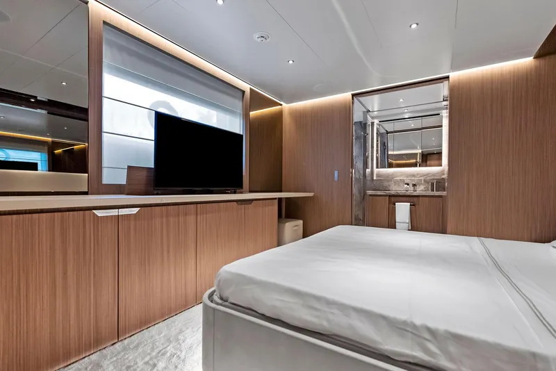 Slide: The Image of Luxurious 2023 Custom Line 106' yacht bedroom with modern wood paneling and sleek design. - 36