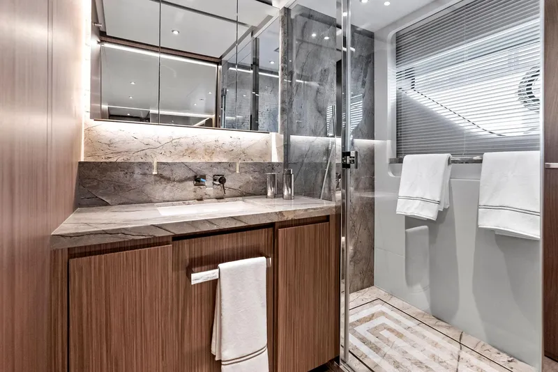 Slide: The Image of Luxurious yacht bathroom with wood cabinetry, marble accents, and modern fixtures, 2023 Custom Line 106'. - 37