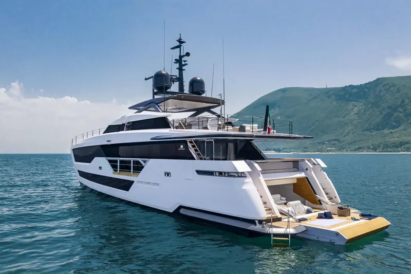 Slide: The Image of Luxurious 2023 Custom Line 106' yacht cruising in scenic coastal waters. - 4