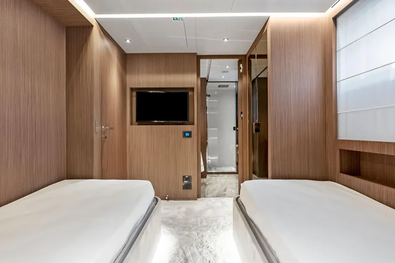 Slide: The Image of Luxurious 2023 Custom Line 106' yacht cabin with twin beds and modern wood paneling. - 41