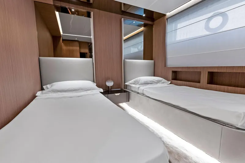 Slide: The Image of Luxurious twin bedroom on 2023 Custom Line 106' yacht, featuring modern design and elegant wood paneling. - 43