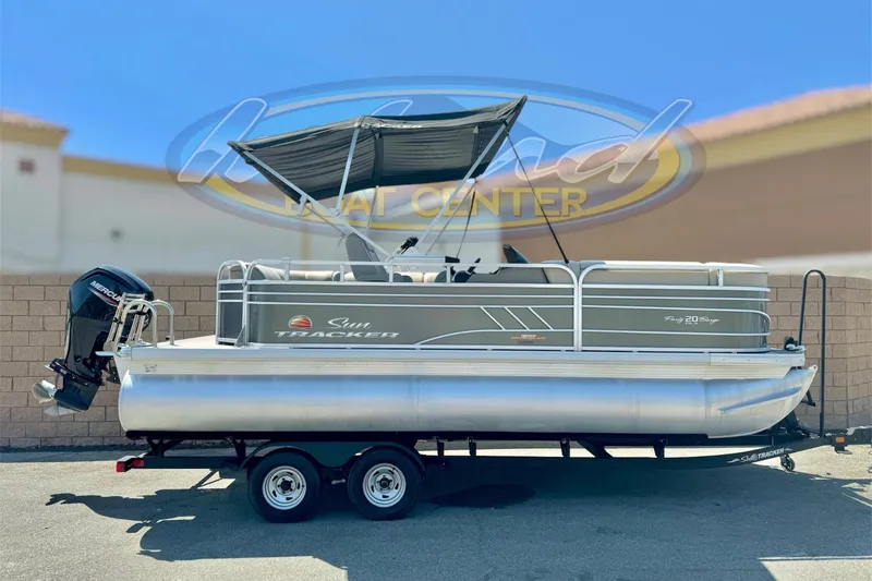 The Image of 2023 Sun Tracker Party Barge 20 DLX pontoon boat on trailer, outdoor display. - 0