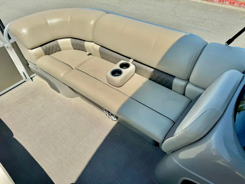 Slide: The Image of 2023 Sun Tracker Party Barge 20 DLX interior seating with cup holders. - 12