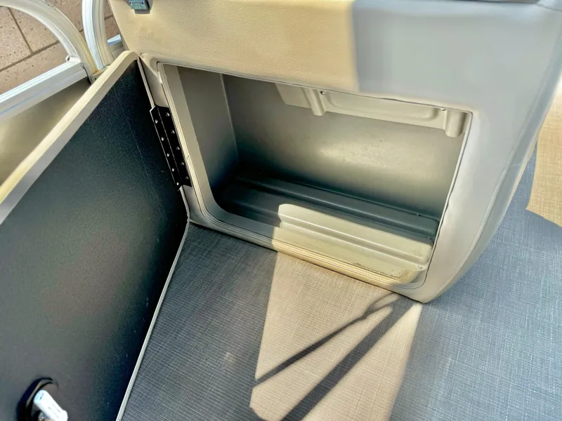Slide: The Image of 2023 Sun Tracker Party Barge 20 DLX storage compartment interior. - 16