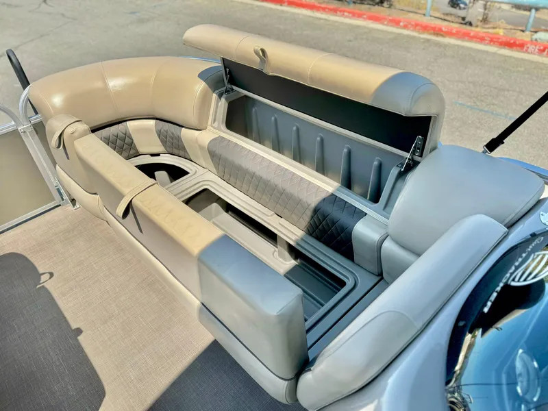 Slide: The Image of 2023 Sun Tracker Party Barge 20 DLX seating area with storage compartments. - 18