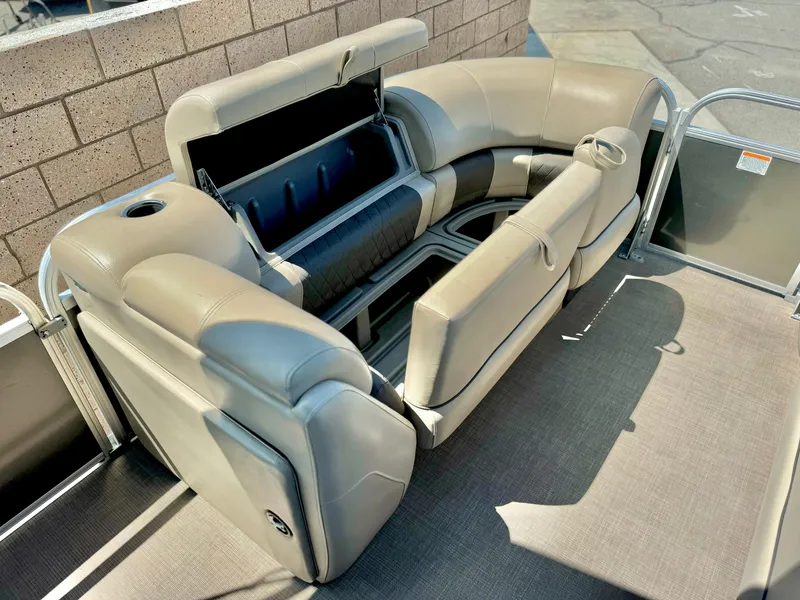 Slide: The Image of 2023 Sun Tracker Party Barge 20 DLX interior seating with storage compartments. - 19