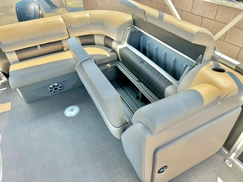 Slide: The Image of 2023 Sun Tracker Party Barge 20 DLX interior with open storage compartment. - 20