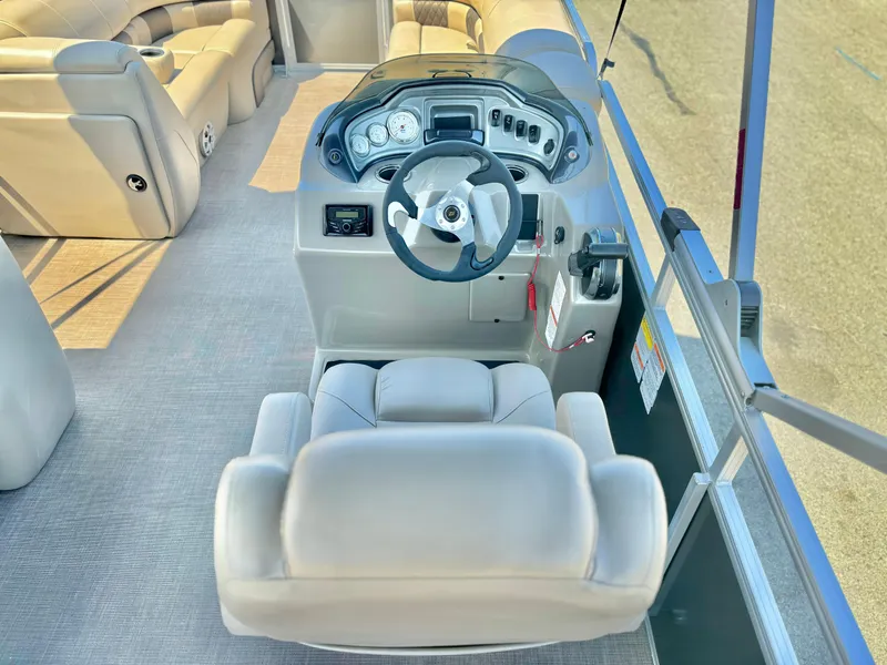 Slide: The Image of 2023 Sun Tracker Party Barge 20 DLX interior with steering console and seating. - 24