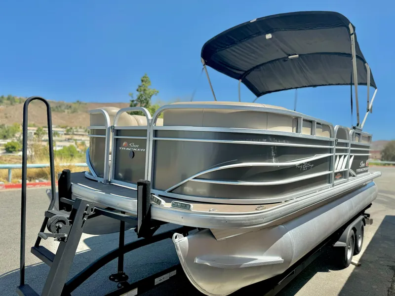 Slide: The Image of 2023 Sun Tracker Party Barge 20 DLX pontoon boat on trailer, with canopy. - 4
