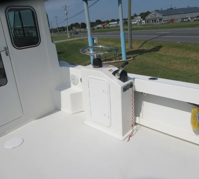 Slide: The Image of 2018 Parker 2320 SL Sport Cabin boat deck with steering wheel and controls. - 13