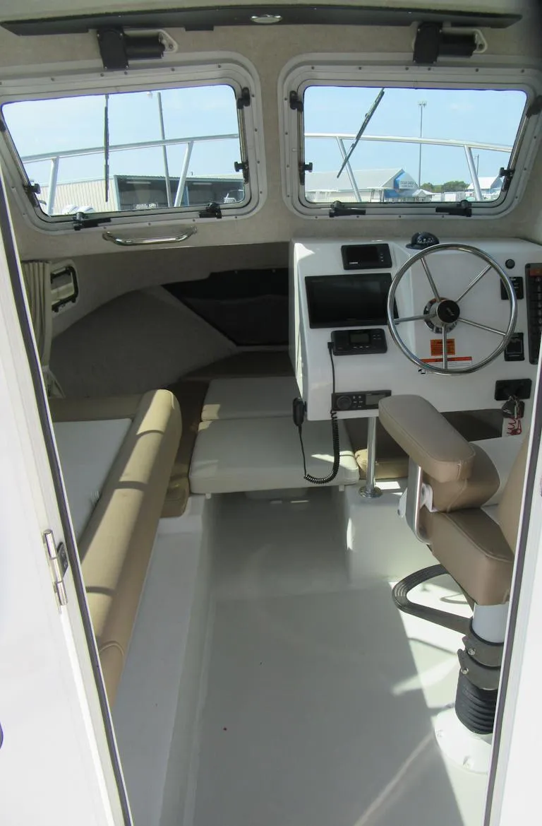 Slide: The Image of 2018 Parker 2320 SL Sport Cabin interior with steering wheel and seating. - 15