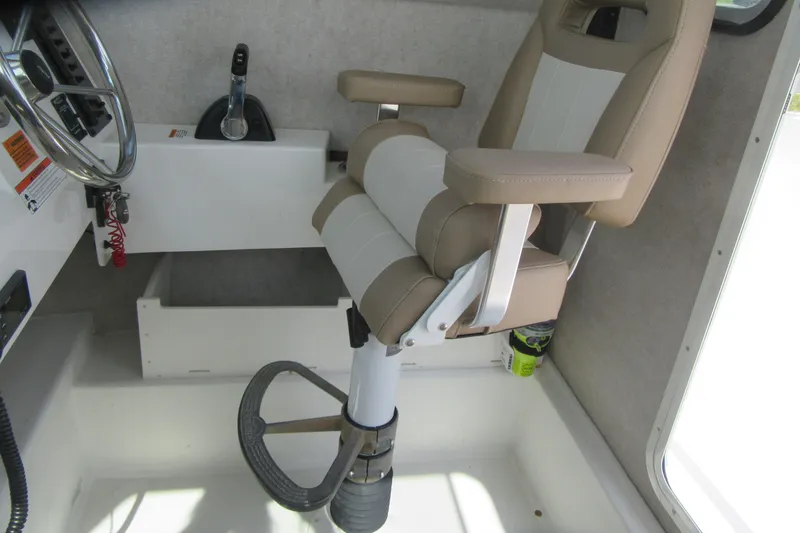Slide: The Image of 2018 Parker 2320 SL Sport Cabin interior with captain's chair and steering controls. - 19