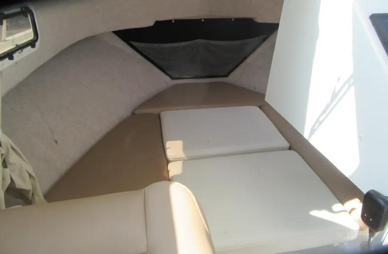 Slide: The Image of Interior cabin of 2018 Parker 2320 SL Sport Cabin boat, featuring cushioned seating. - 23