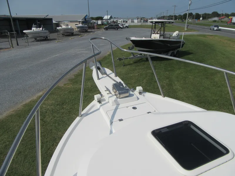 Slide: The Image of 2018 Parker 2320 SL Sport Cabin boat on display at a marina. - 25