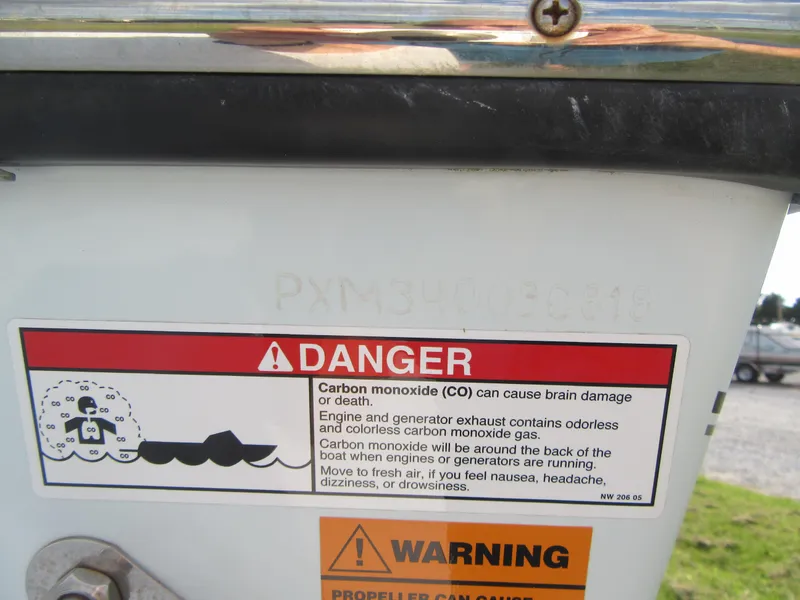 Slide: The Image of Danger warning label on 2018 Parker 2320 SL Sport Cabin boat, cautioning about carbon monoxide risks. - 5