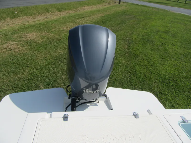 Slide: The Image of 2018 Parker 2320 SL Sport Cabin boat with powerful outboard motor on grassy background. - 8