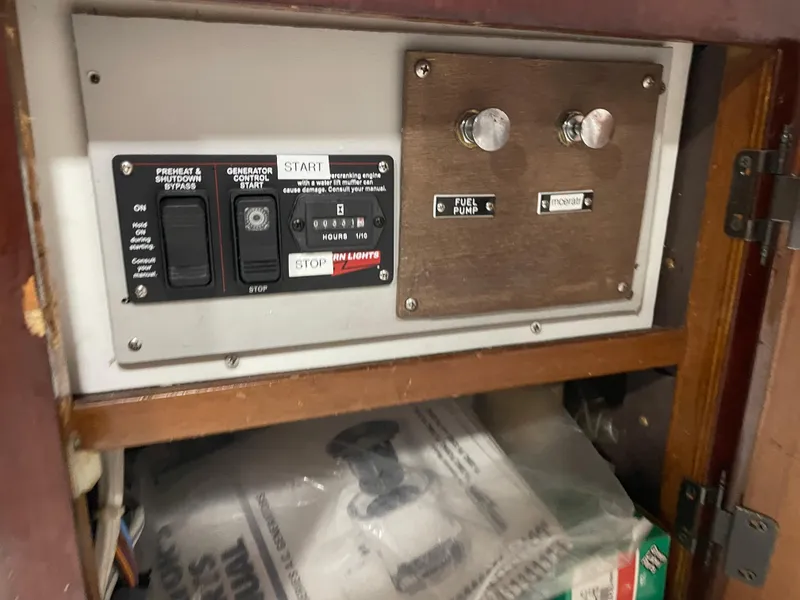 Slide: The Image of Control panel of a 1986 Post 43 Sport Fisher boat, featuring switches and dials. - 15