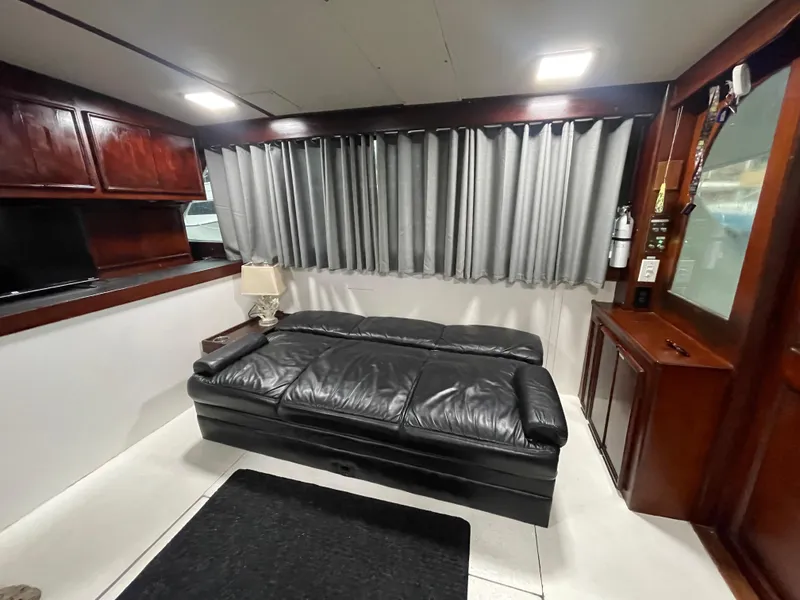 Slide: The Image of Interior of 1986 Post 43 Sport Fisher with leather sofa and wooden cabinetry. - 16