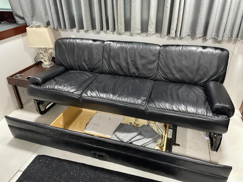 Slide: The Image of Black leather sofa in a 1986 Post 43 Sport Fisher boat interior. - 17