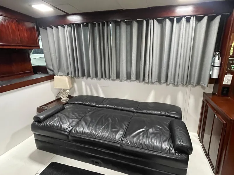 Slide: The Image of Interior of 1986 Post 43 Sport Fisher with black leather sofa and elegant wood accents. - 18