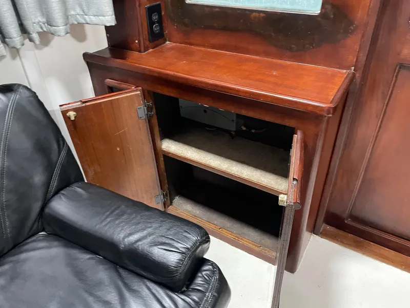 Slide: The Image of 1986 Post 43 Sport Fisher interior with open wooden cabinet and black leather chair. - 20