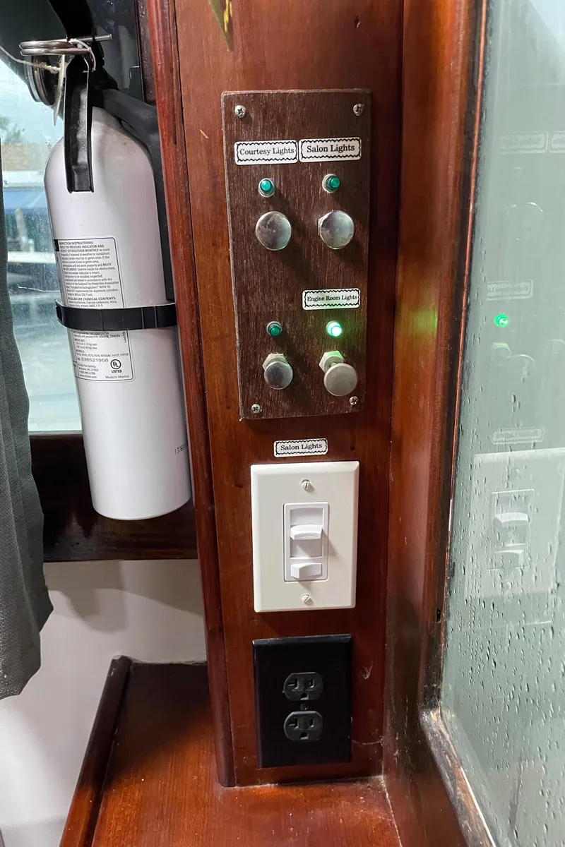 Slide: The Image of Control panel and outlets on 1986 Post 43 Sport Fisher boat interior. - 22