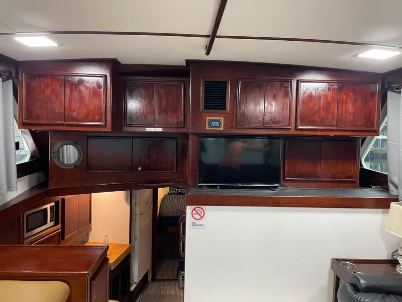 Slide: The Image of 1986 Post 43 Sport Fisher interior with wooden cabinets and modern amenities. - 23