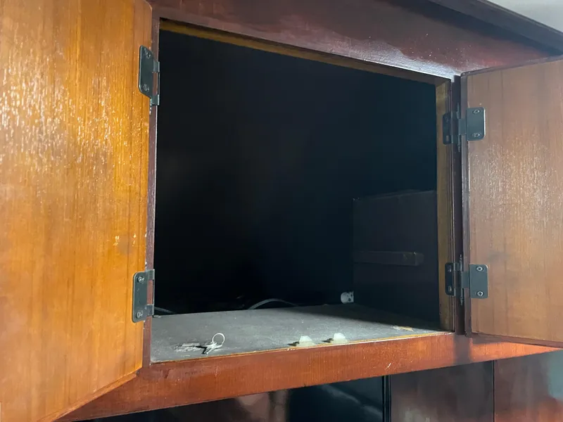 Slide: The Image of Open wooden cabinet on 1986 Post 43 Sport Fisher boat. - 26