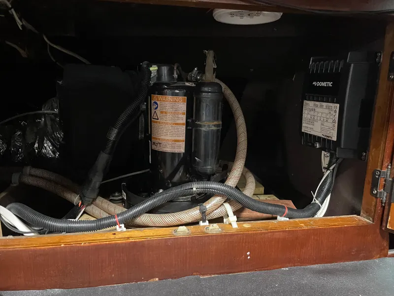 Slide: The Image of 1986 Post 43 Sport Fisher engine compartment with wiring and components. - 27