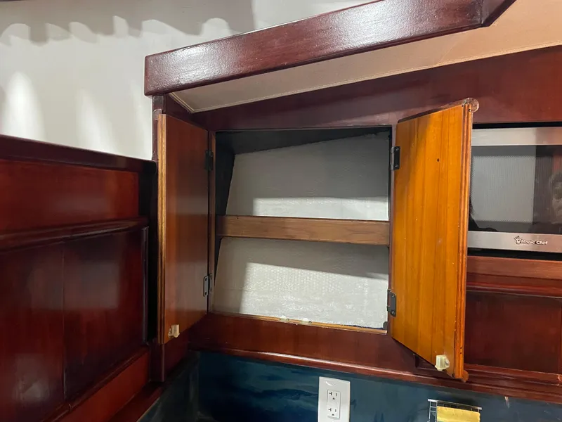 Slide: The Image of Open wooden cabinet in 1986 Post 43 Sport Fisher boat interior. - 32