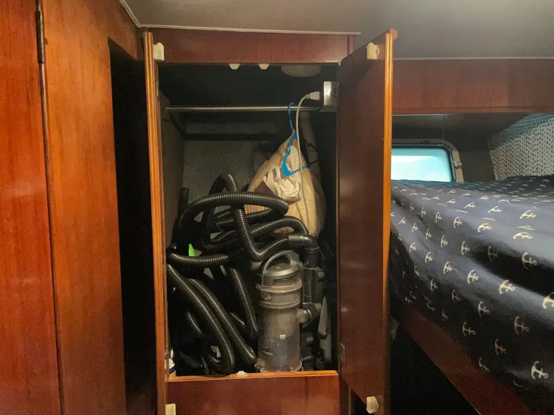 Slide: The Image of 1986 Post 43 Sport Fisher interior with storage cabinet and vacuum equipment. - 39