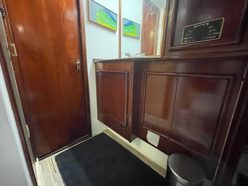 Slide: The Image of Interior of 1986 Post 43 Sport Fisher yacht with wooden cabinetry and mirror. - 40