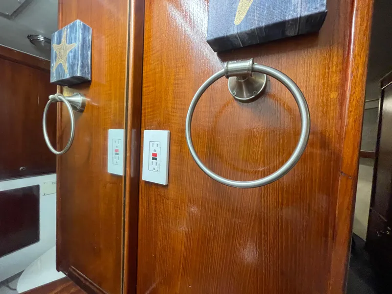 Slide: The Image of Wooden interior of 1986 Post 43 Sport Fisher with towel ring and light switches. - 43