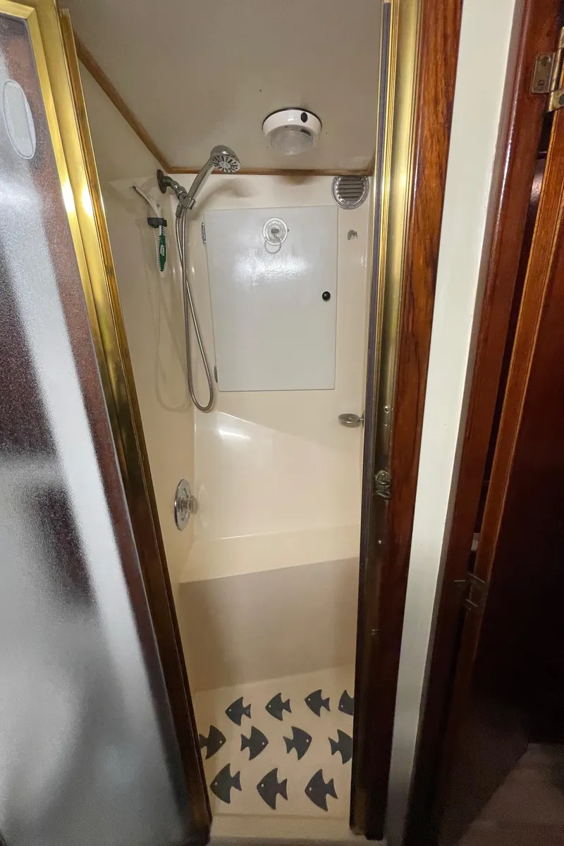 Slide: The Image of 1986 Post 43 Sport Fisher shower with white walls and patterned floor. - 46