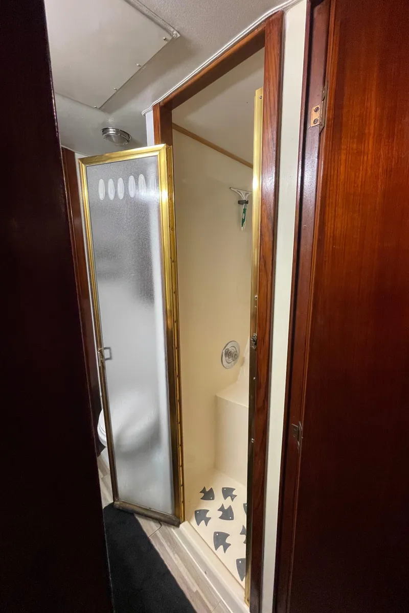 Slide: The Image of 1986 Post 43 Sport Fisher bathroom with shower and wooden accents. - 47