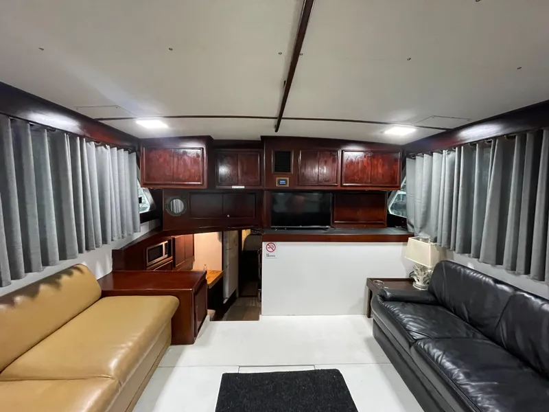 Slide: The Image of Interior of 1986 Post 43 Sport Fisher yacht with sofas and wooden cabinetry. - 6