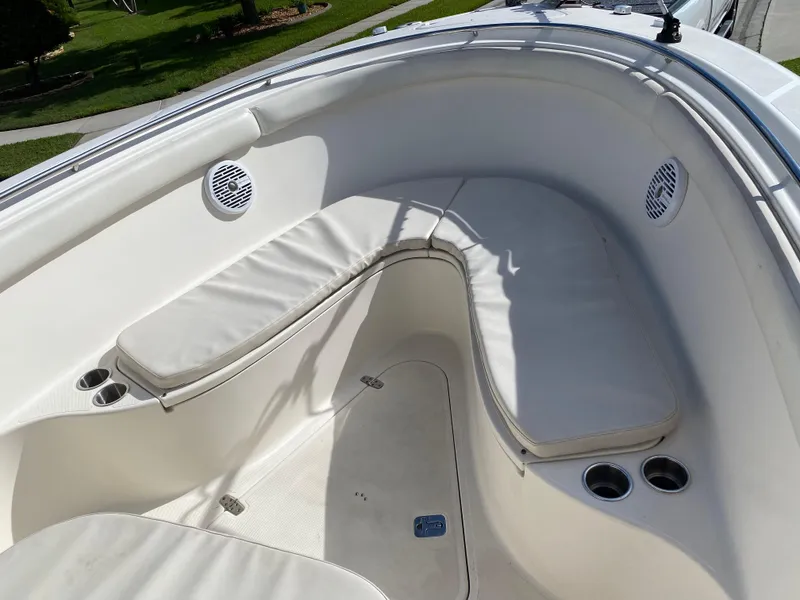 Slide: The Image of 2007 Pursuit 310 Center Console boat with cushioned seating and cup holders. - 10