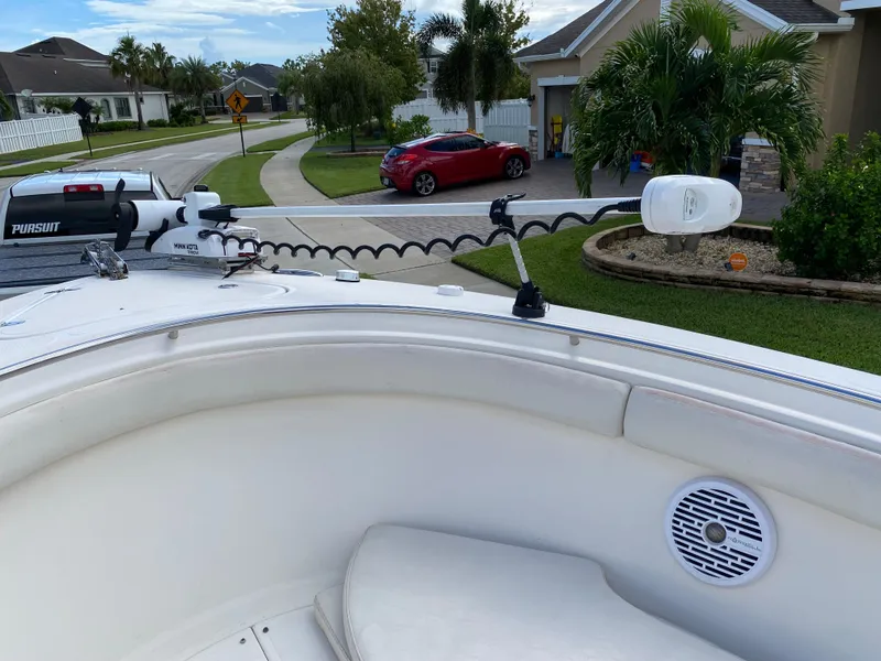 Slide: The Image of 2007 Pursuit 310 Center Console boat parked in a suburban neighborhood driveway. - 13