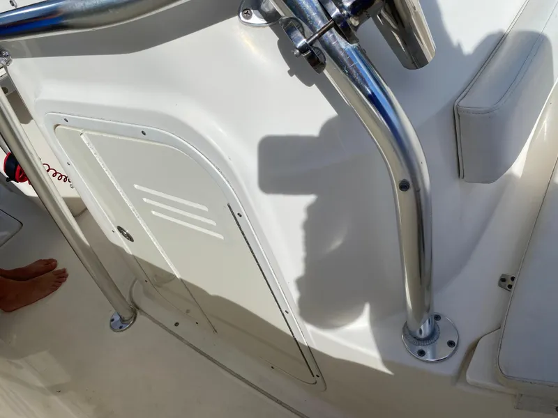 Slide: The Image of 2007 Pursuit 310 Center Console boat interior with stainless steel railing and storage compartment. - 16