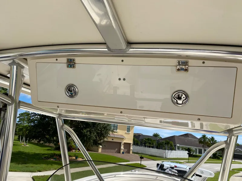 Slide: The Image of 2007 Pursuit 310 Center Console storage compartment with stainless steel fixtures. - 23