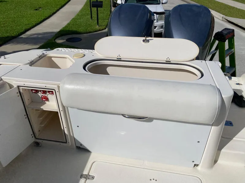 Slide: The Image of 2007 Pursuit 310 Center Console boat with open storage compartments and seating. - 29