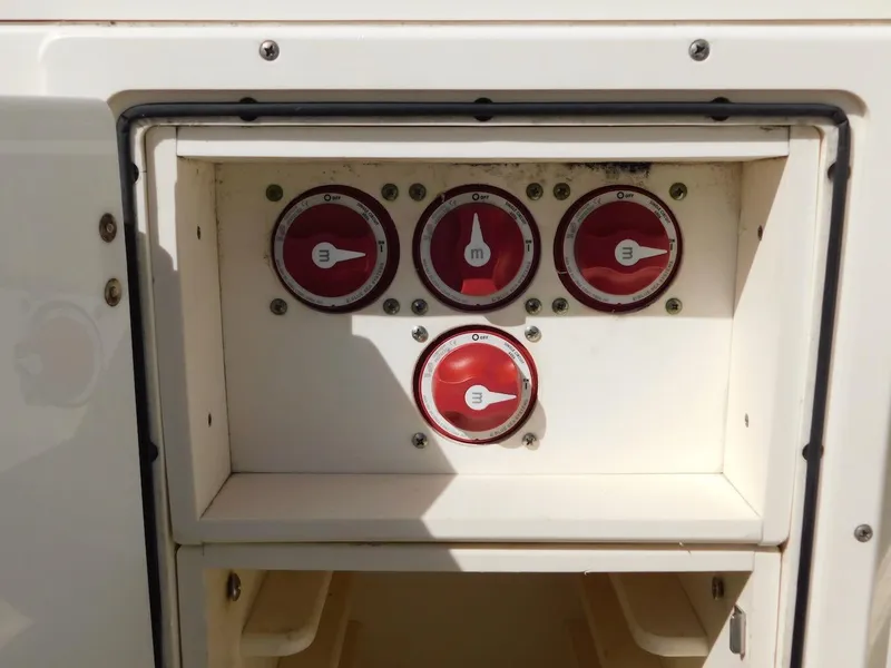 Slide: The Image of Control panel with red switches on a 2007 Pursuit 310 Center Console boat. - 30