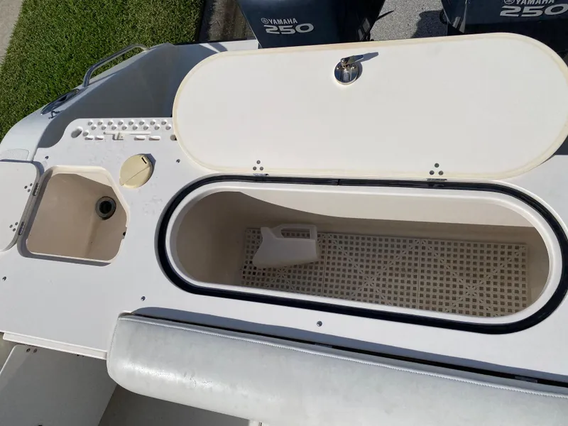 Slide: The Image of 2007 Pursuit 310 Center Console boat storage compartment and seating area. - 31