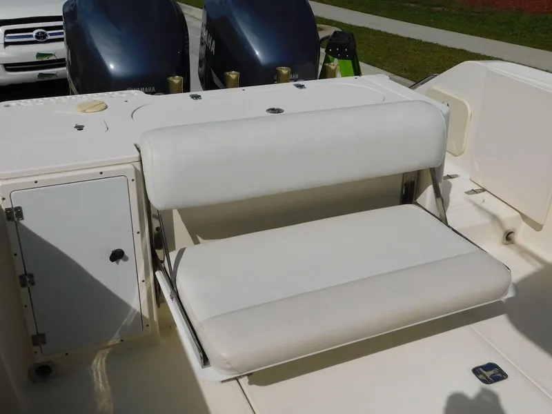 Slide: The Image of 2007 Pursuit 310 Center Console boat with cushioned seating and dual engines. - 32