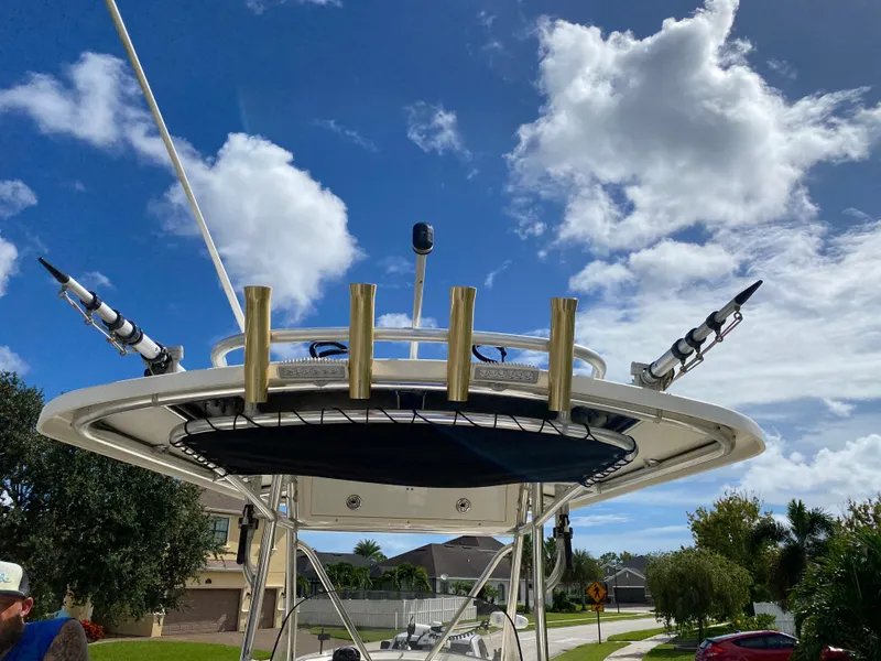 Slide: The Image of 2007 Pursuit 310 Center Console boat with rod holders under a blue sky. - 35