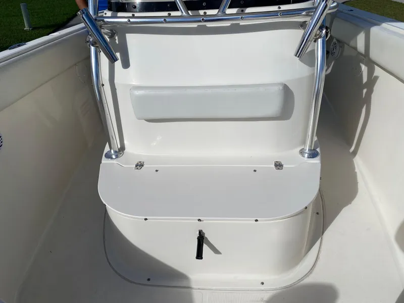 Slide: The Image of 2007 Pursuit 310 Center Console boat interior with seating and stainless steel railings. - 8